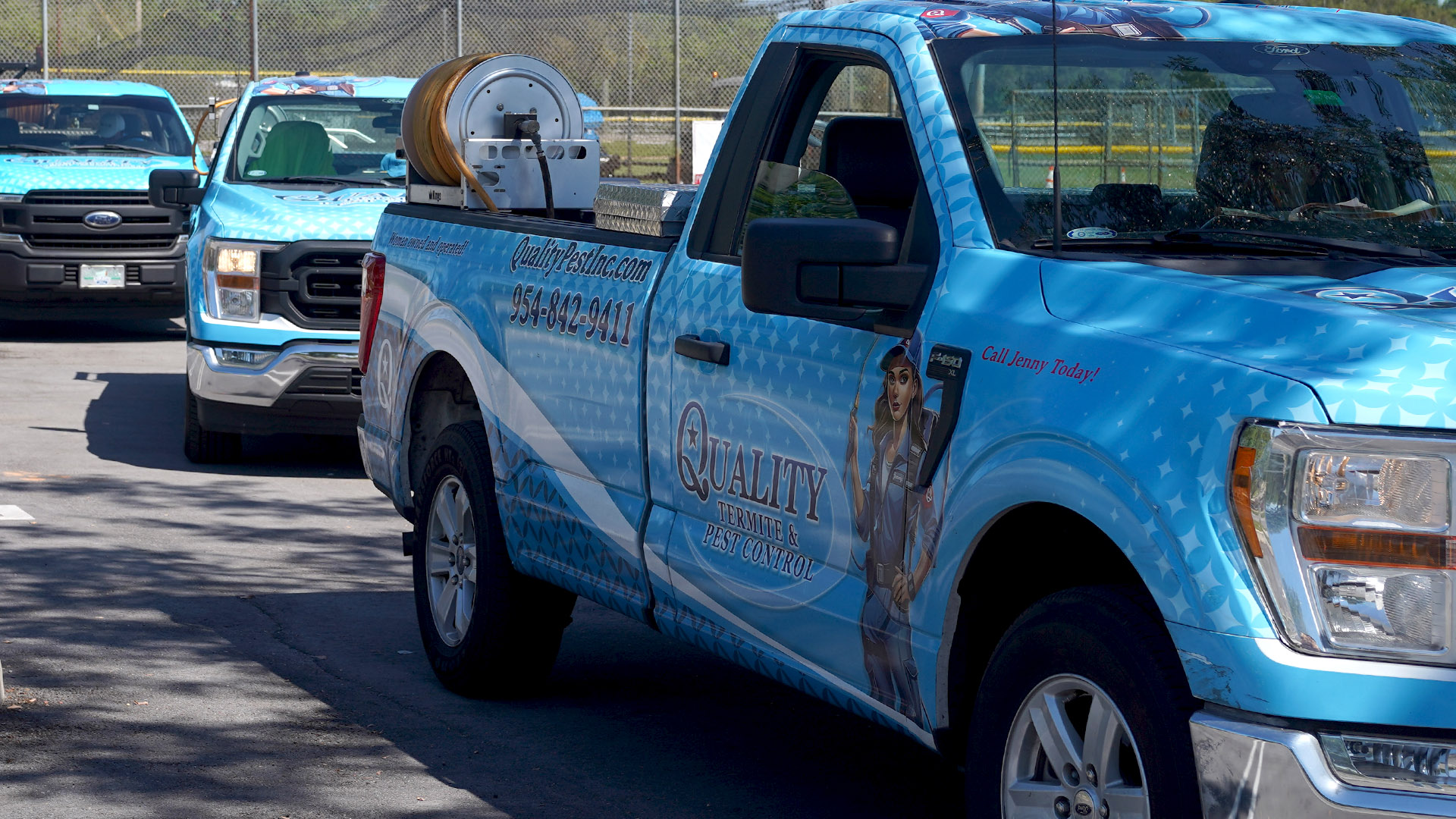 Roach Control Company in Sunrise FL - Quality Termite and Pest Control Blue pest-control truck with a hose reel and company branding parked in a lot, with another blue truck in the background.